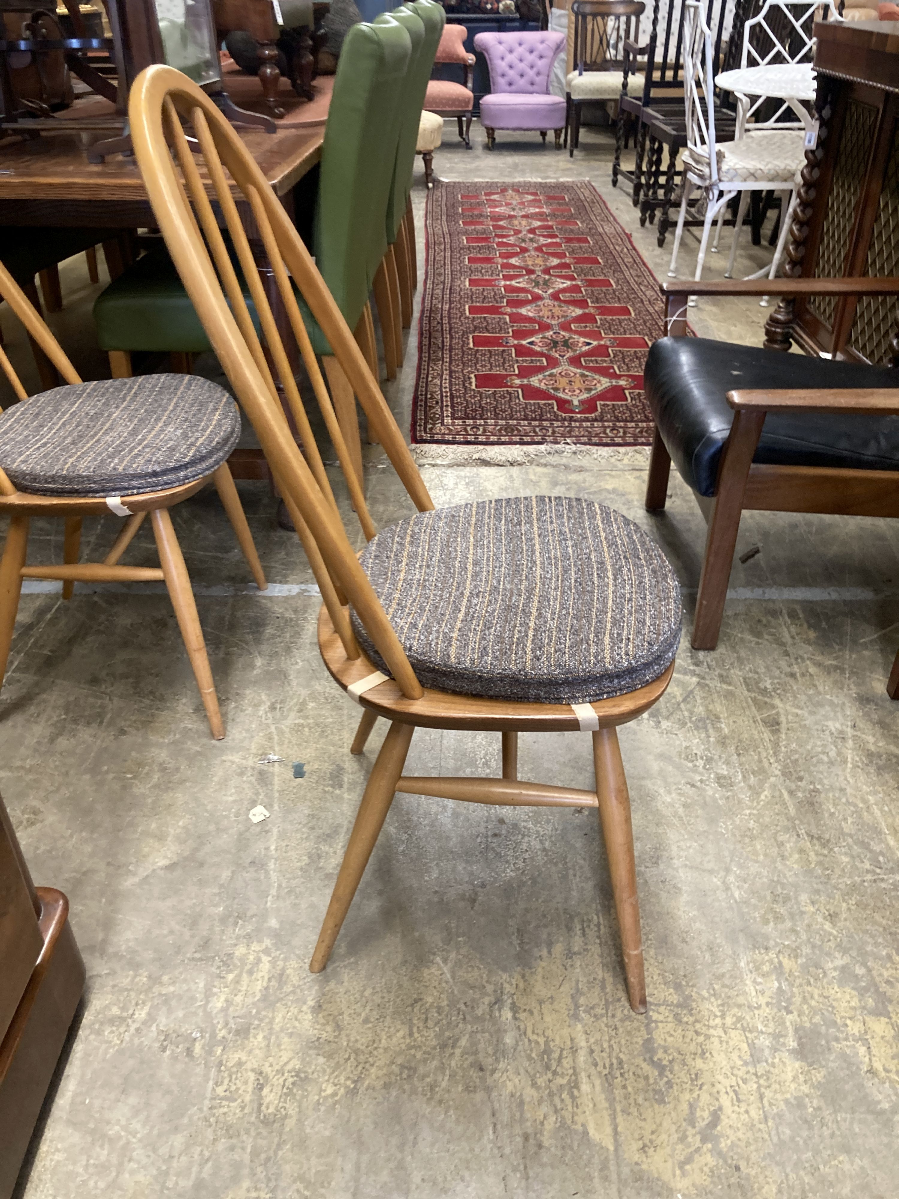 A set of four Ercol light beech comb back Windsor dining chairs